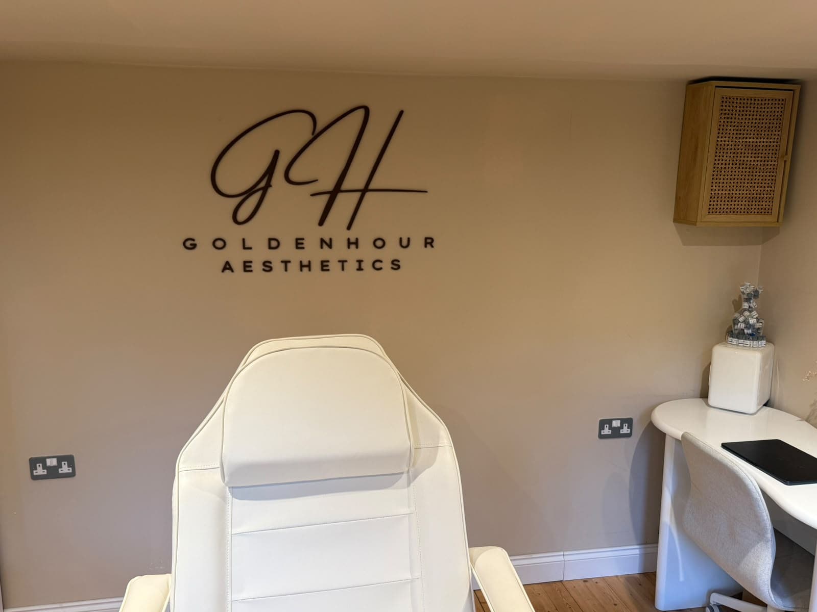 Golden Hour Aesthetics treatment room with branded wall and treatment chair